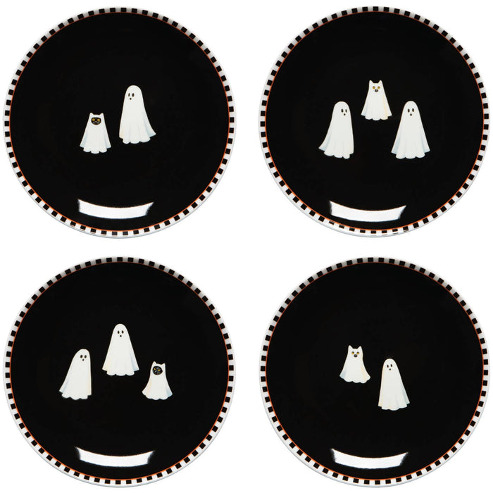 Four black appetizer plates with ghost faces