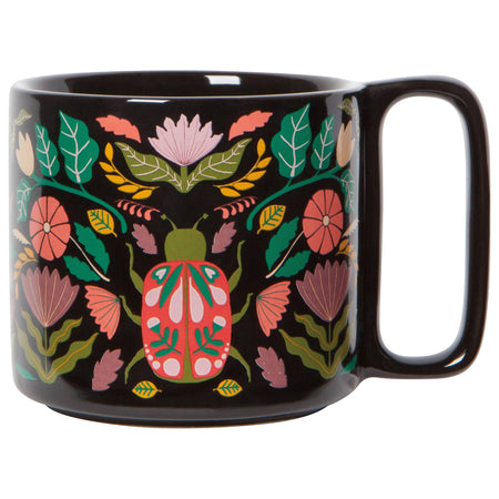 Black stoneware mug with scarab beetle and botanical pattern